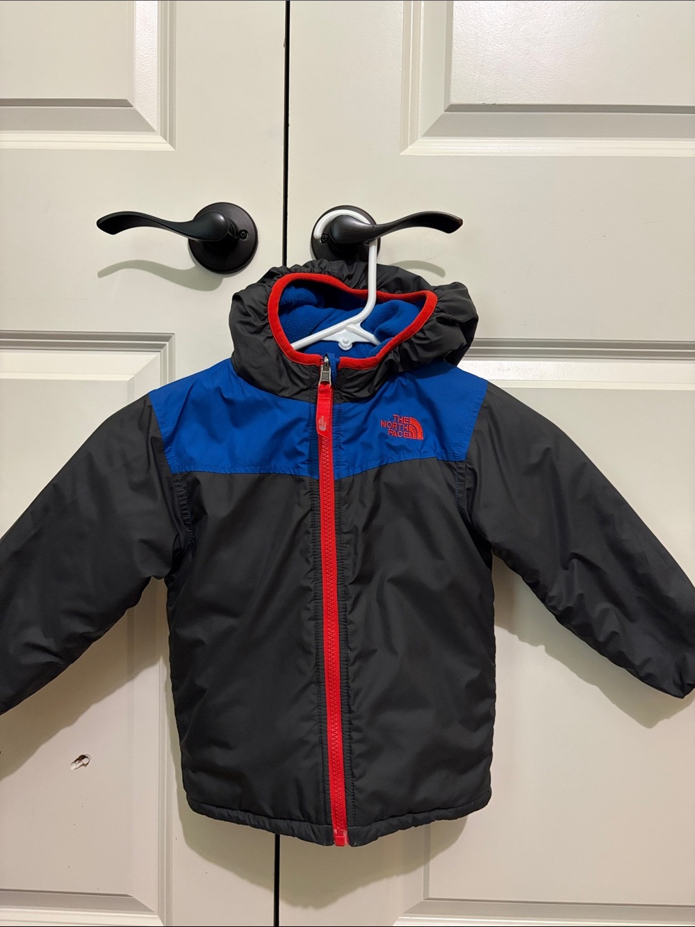 The North Face Kids Black Jacket with Blue Yoke and Red Trim